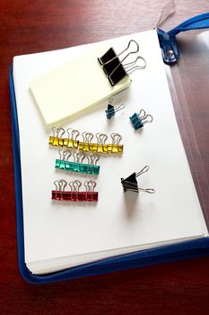 folder sheets and paper clips on a desk