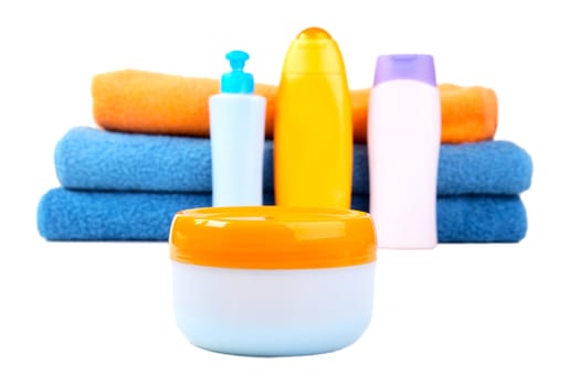 Terry towels and tubes with cosmetics isolated on a white background