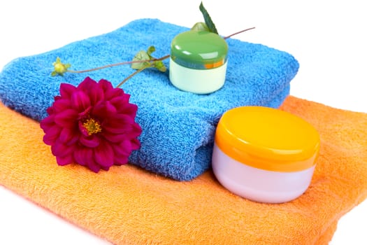 Terry towels tubes and a flower isolated on a white background