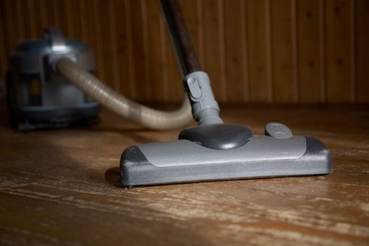 The vacuum cleaner cleans floor in a room