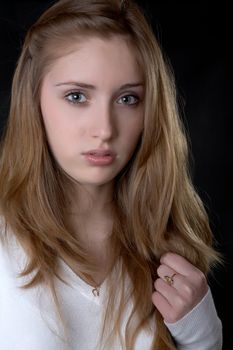 Portrait of the serious girl  with jewelry on a black background