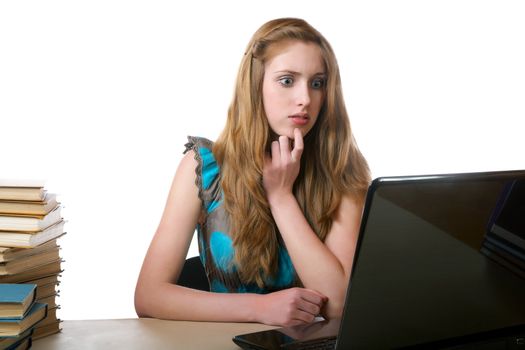 girl with surprise looks at the laptop screen