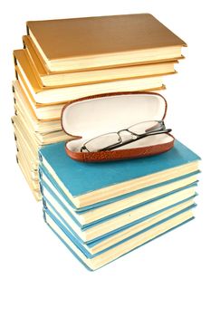 Pile of old books and glasses on a white background