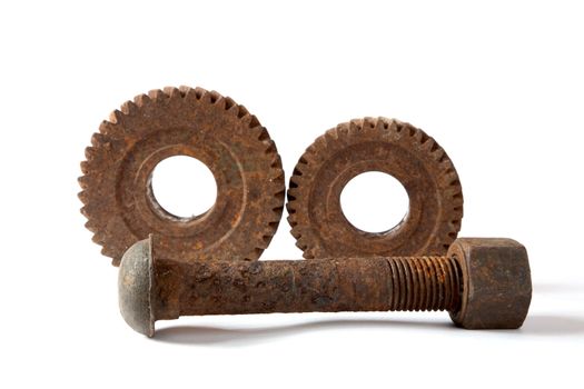 Rusty gears and bolt with a nut  on  white background isolated