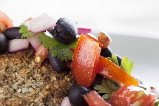 Closeup of black bean salsa on a veggie burger