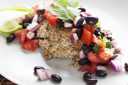 Black bean salsa on a veggie burger with lime garnish