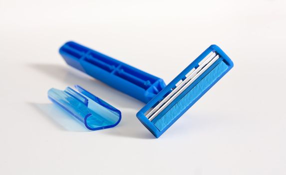 Close up photo of blue razor isolate on white background.