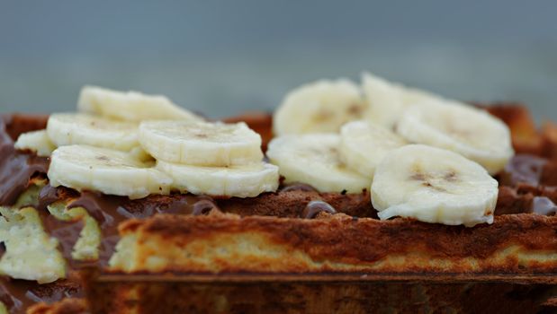 Delicious waffles with fruits and chocolate