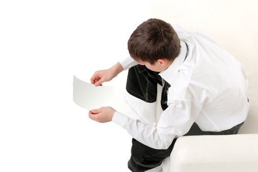 pensive teenager looking on the blank paper