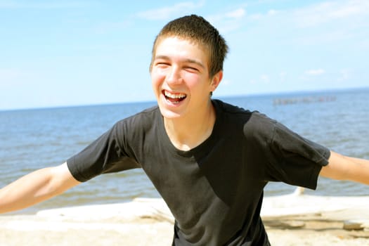 happy teenager running on the beach