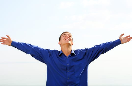 happy teenager on the sky background in the sunny day