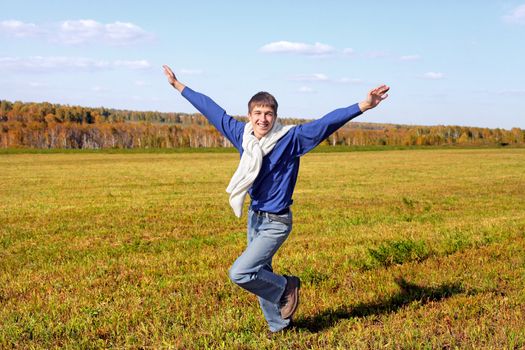 happy teenager running on the autumn field