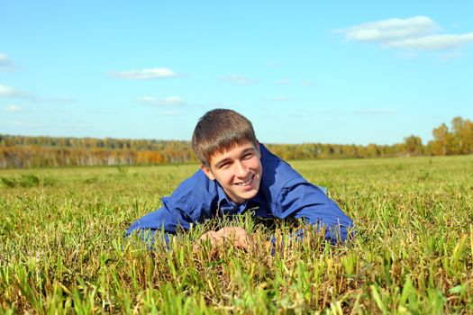 happy teenager lying in the field