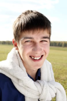 happy and smiling teenager portrait in the field