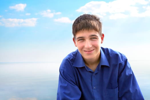 smiling young man portrait on the sea background