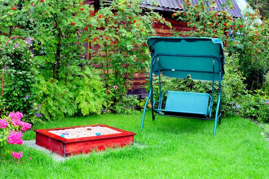 recreation place outdoor with sandbox and seesaw