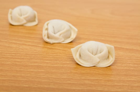 homemade meat dumplings on a cutting board 