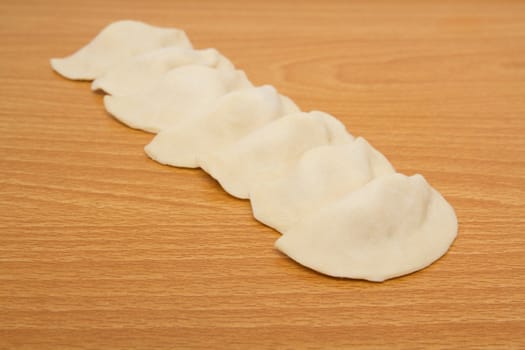 homemade meat dumplings on a cutting board 