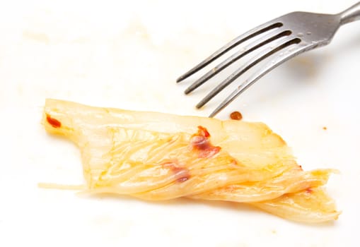 Korean cabbage with chili and a fork on a white background