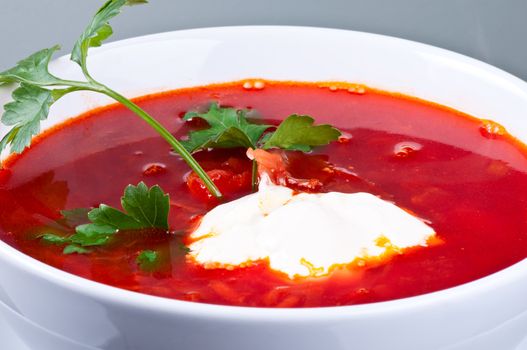 Homemade red-beet soup with parsley and sour cream