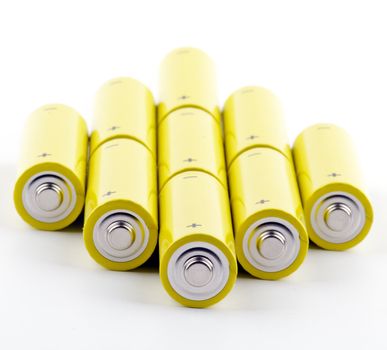 Arrangement of colorful yellow Batteries isolated on white background