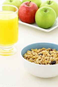 delicious and healthy granola or muesli with a fresh organic apples and orange juice, nuts and grains. 