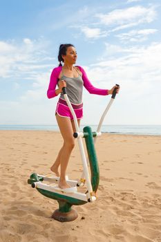 An outdoor fitness machine on a scenic beach location