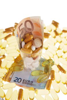 Pills and the euro on a white background