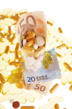 Pills and the euro on a white background