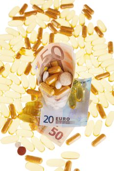 Pills and the euro on a white background