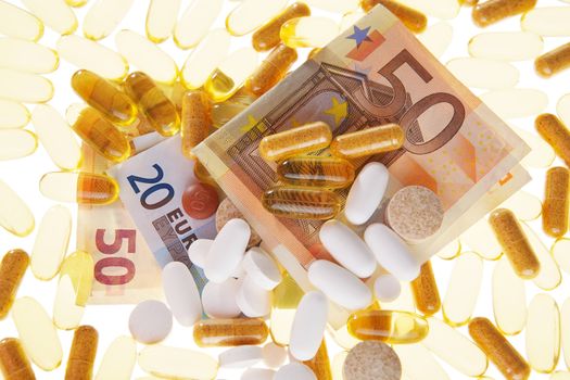 Pills and the euro on a white background