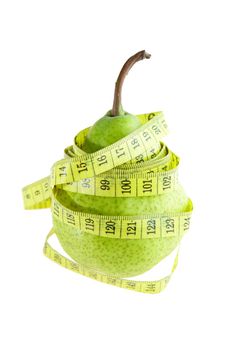 Ripe green pear with measuring tape