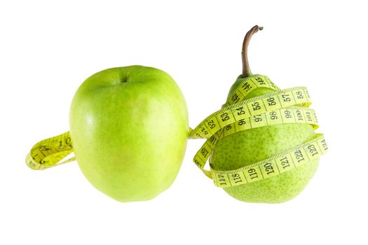 Ripe green pear and apple with measuring tape