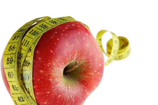 Ripe red apple with measuring tape 