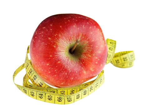 Ripe red apple with measuring tape 