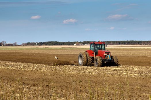 tractors working in the field in early spring