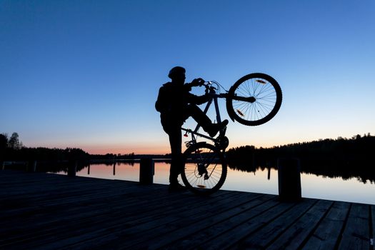 Silhouette of a Cyclist on the background of the Sunset Sky