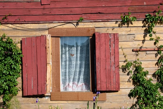 old house with windows and wooden shutters