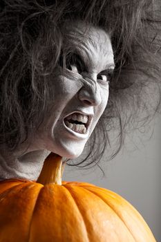 Woman with a bleached face and pumpkin. Halloween theme.