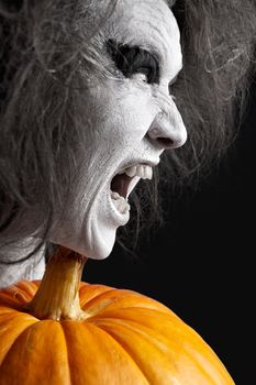 Woman with a bleached face and pumpkin. Halloween theme.