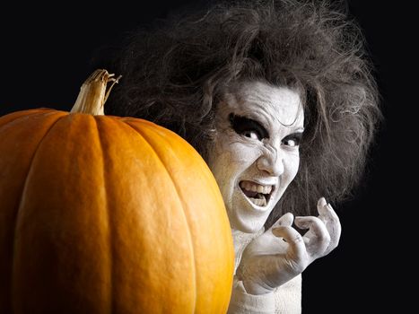 Woman with a bleached face and pumpkin. Halloween theme.