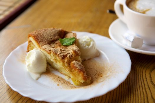 Apple pie with ice cream and cinnamon and coffee