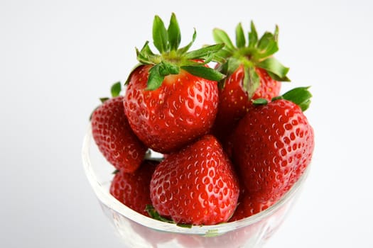 Strawberry in glass container on white background