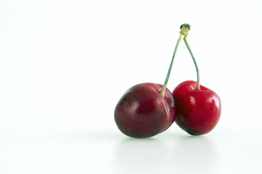 Fresh red cherries with stem on the white background