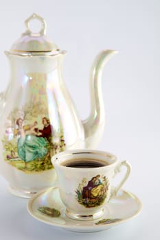 Beautiful old coffee pot and cup with a drawing