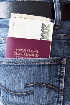 Photo of Czech passport and banknotes in the back pocket of woman's jeans