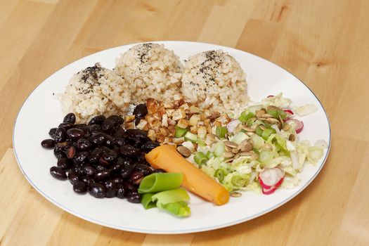 Healthy macrobiotic meal on white plate.