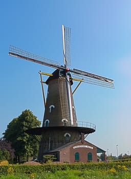 Photo of traditional dutch windmill with blue sky.