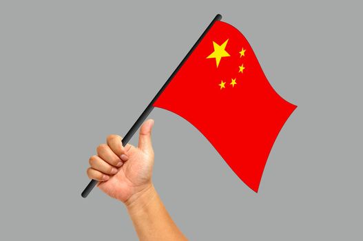 Hand holding China flag isolated on white background
