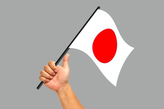 Hand holding japan flag isolated on white background